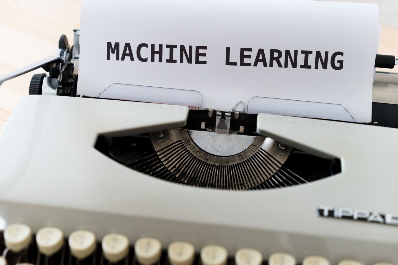 about-img Vintage typewriter displaying 'Machine Learning' text, blending old and new concepts.