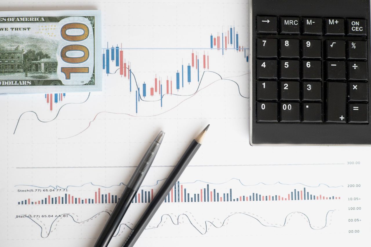 services-03 Stock analysis workspace featuring charts, a calculator, and currency for data-driven insights.